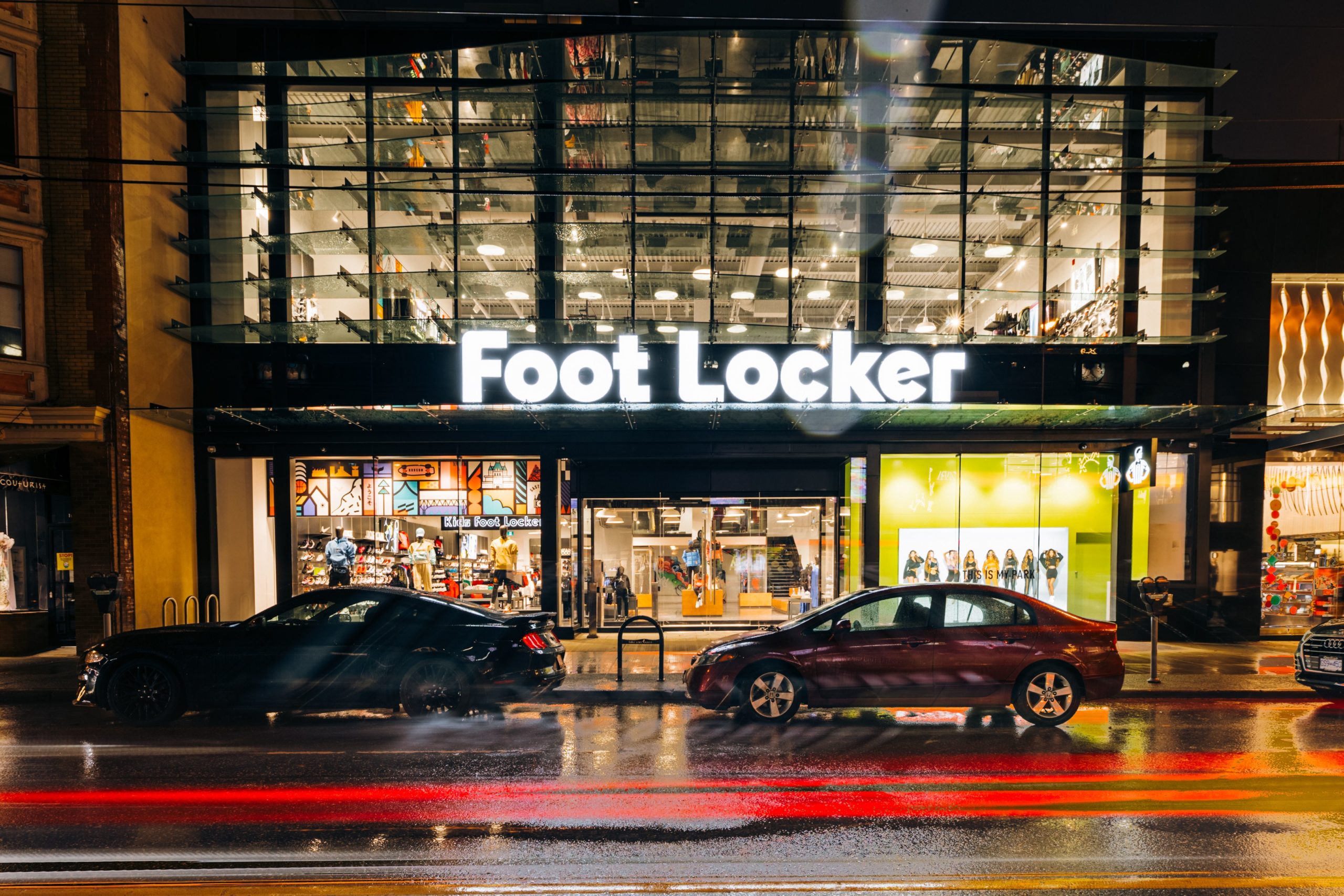 Foot Locker storefront with customers exploring athletic footwear releases