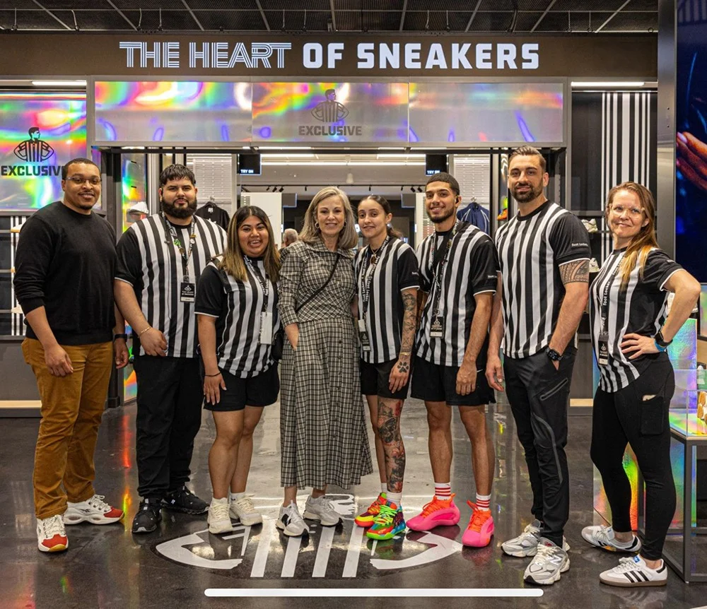 Program team reviewing Foot Locker store plans and merchandising layouts